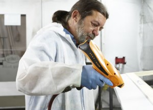 A paint technician spraying some profile